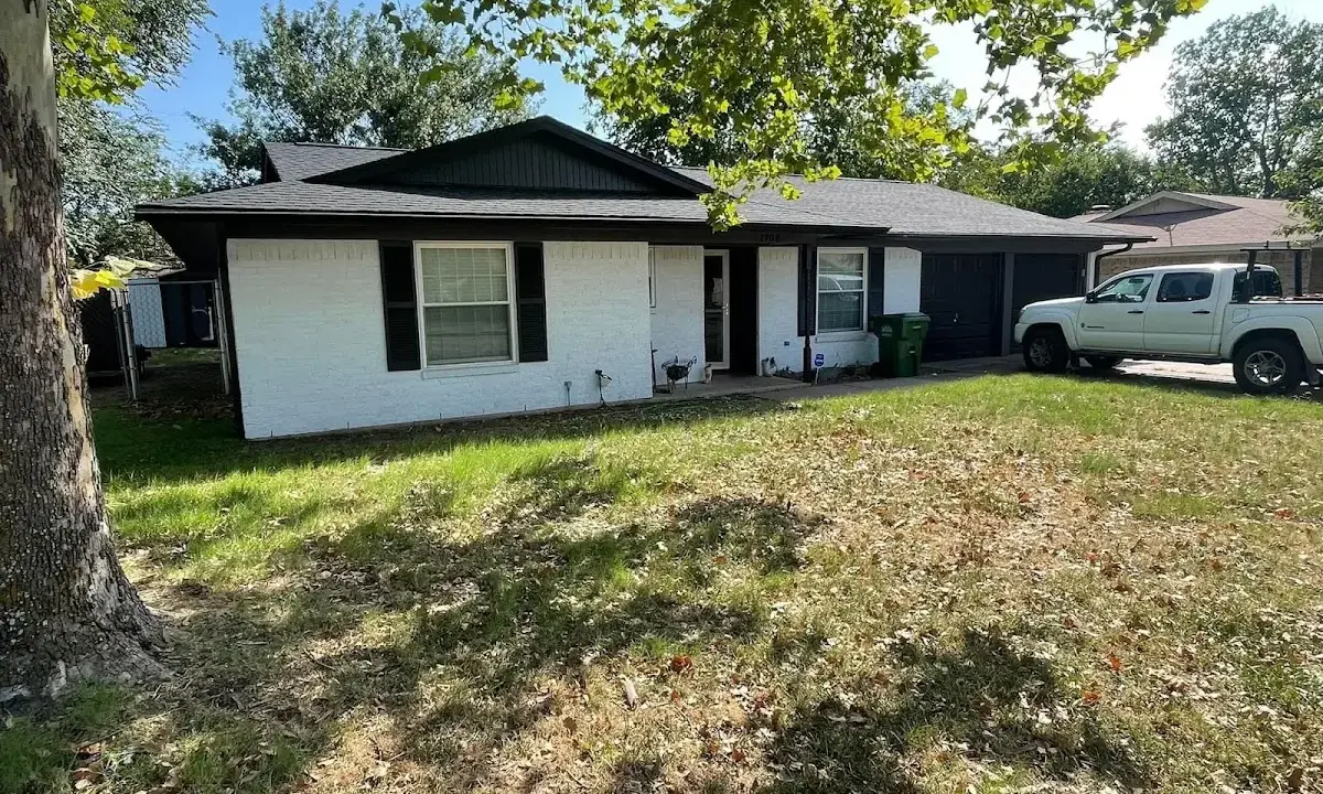 Professional roofing crew working on a residential roof in Walton